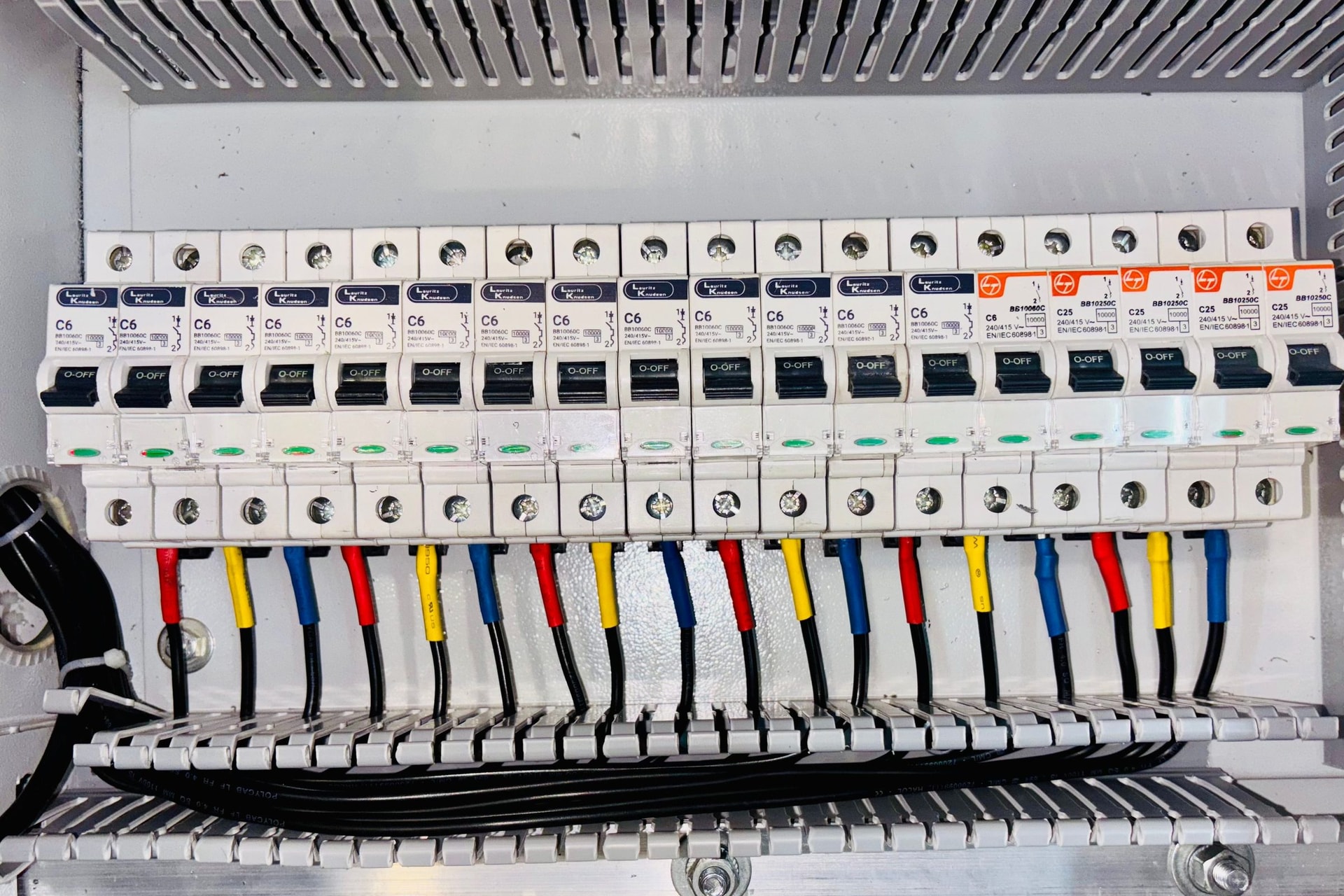 A row of circuit breakers in an electrical distribution board.